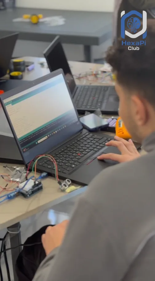 A student coding a live circuit in the Arduino IDE